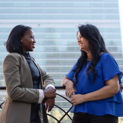Two UNFCU staff members speaking outside of the United Nations in New York City.